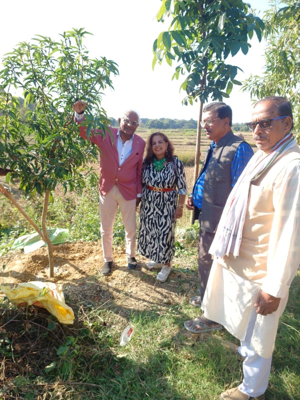 Group photo under newly-planted trees at the farm