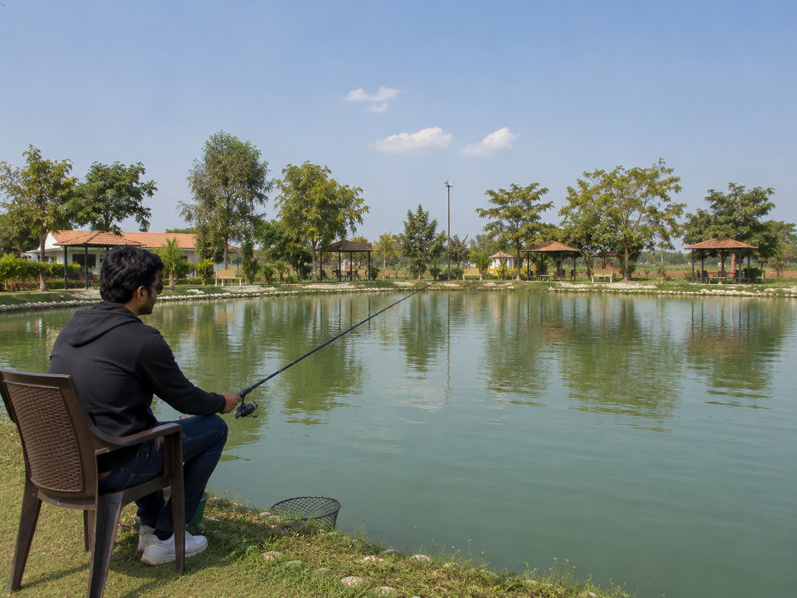 A landscaped pond at the farm with seating spots for anglers