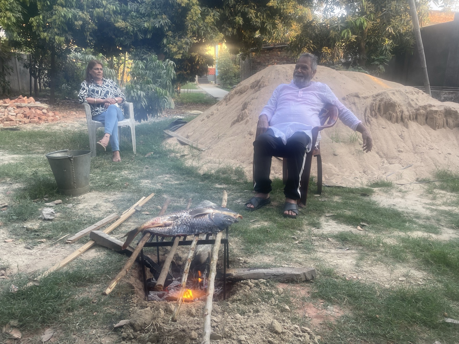 Pond-fresh fish grilling on an open fire
